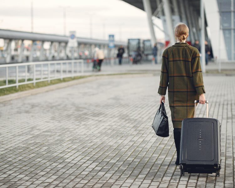 woman-leaving-airport-with-luggages